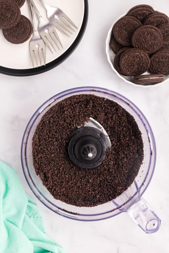 Crushed chocolate cookies in a food processor.