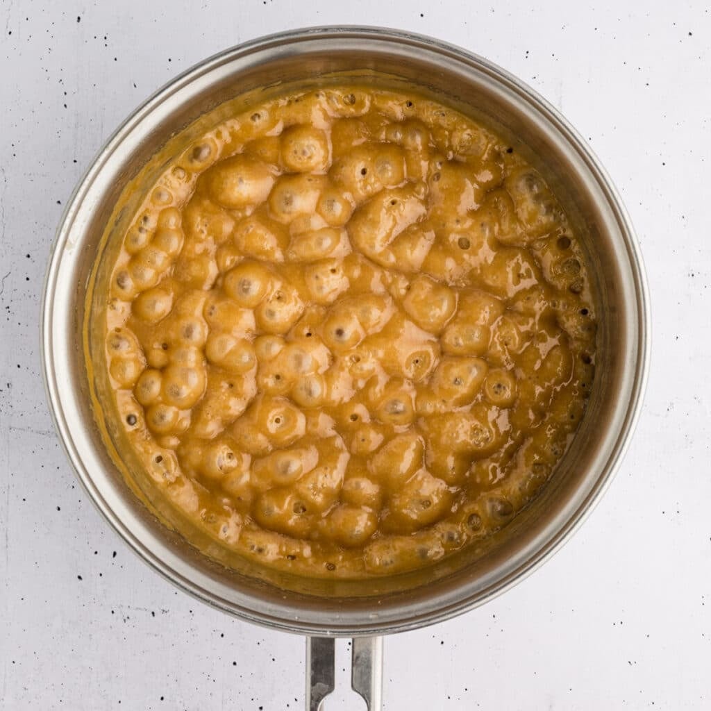 Bubbling caramel mixture in a saucepan.