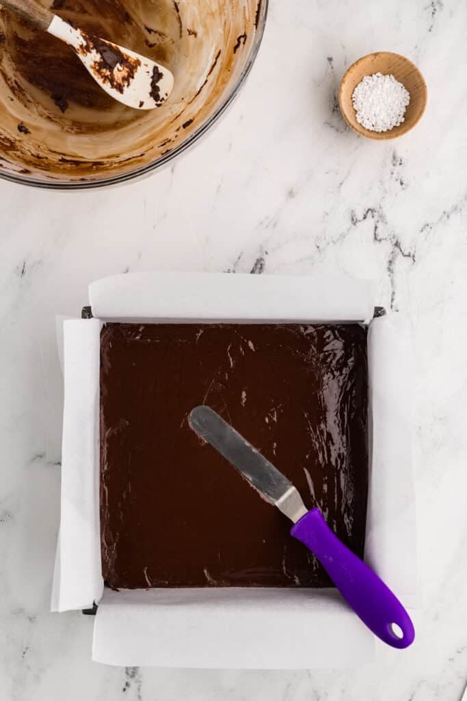 Smoothed fudge batter in a pan.