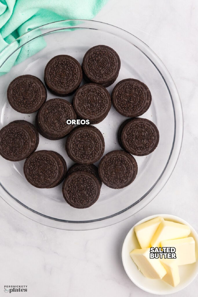 Oreos and butter labeled as ingredients in a pie dish.