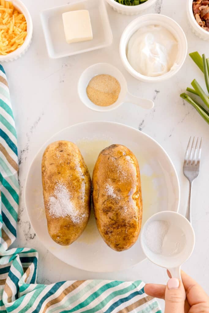 salt being sprinkled on potatoes.