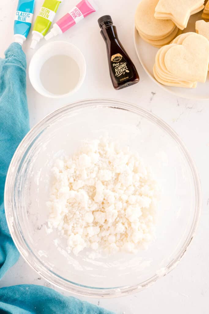 overhead shot of crumbly powdered sugar mixture in a bowl.