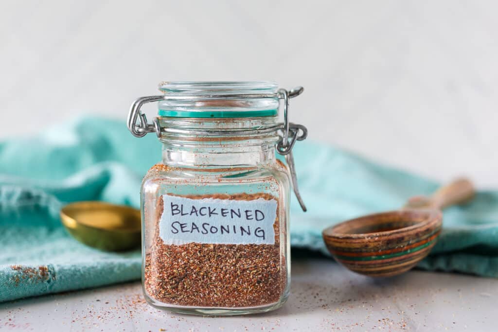 side view of a jar of labeled homemade blackened seasoning.
