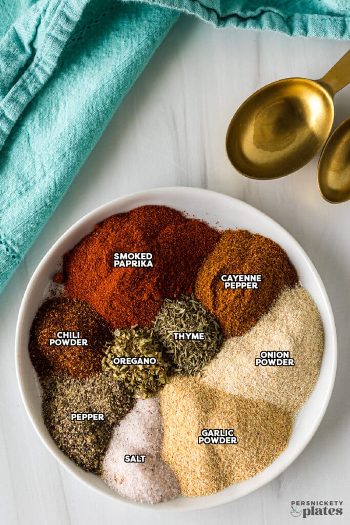 a plate with piles of neatly arranged spices to make blackend seasoning.