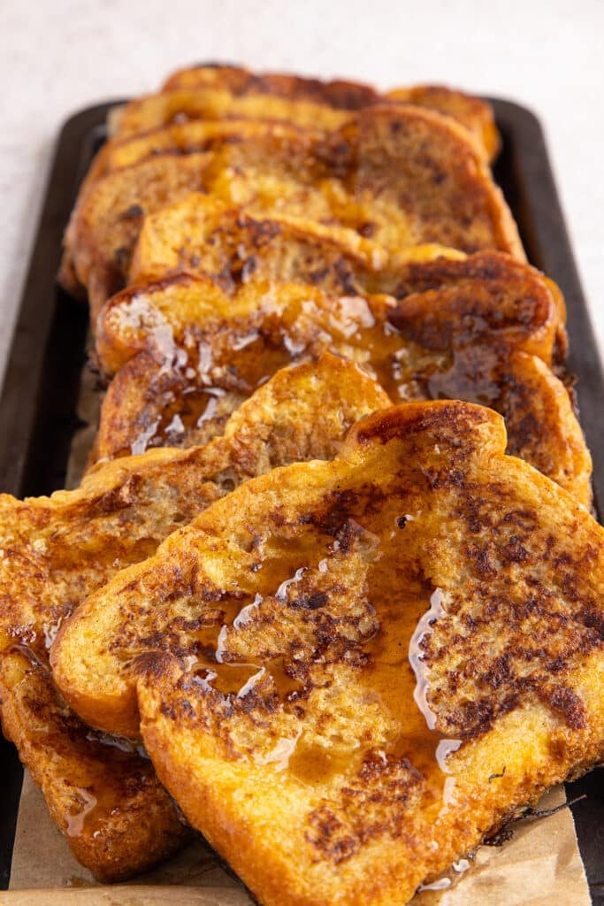 plate of french toast drizzled with syrup.