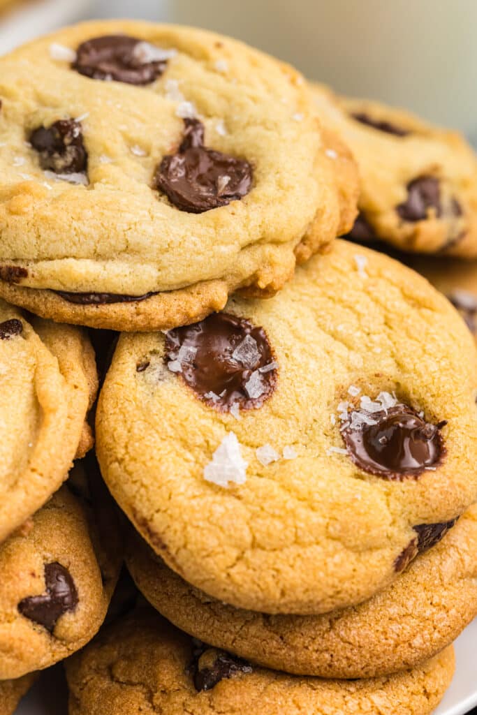 close up shot of chocolate chip cookies with melty chips, sprinkled with sea salt.