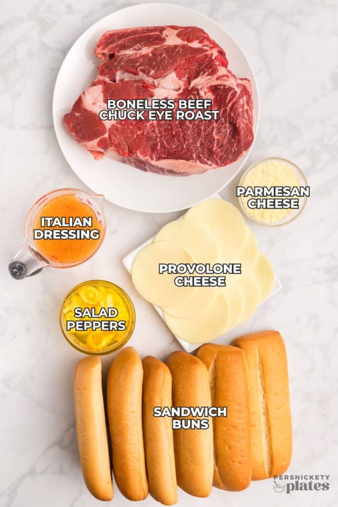 Flat lay of labeled ingredients for slow cooker Italian beef on a white background.