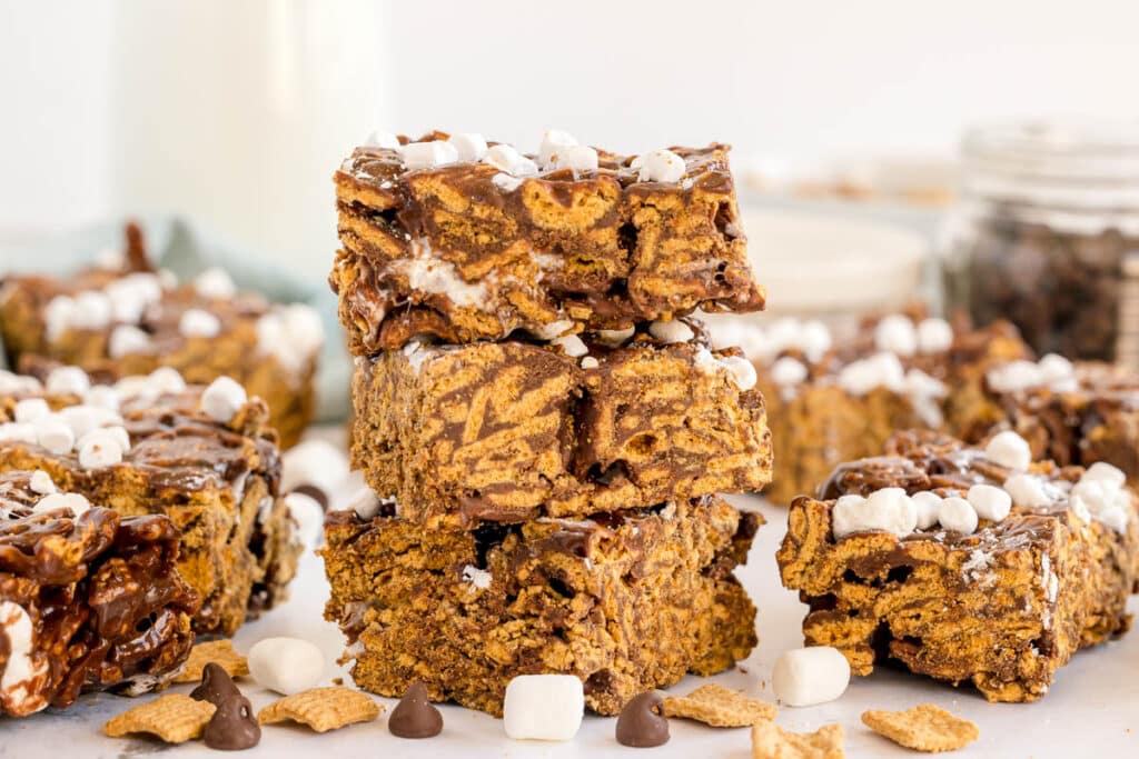 Three stacked s’mores bars with marshmallow and chocolate layers.