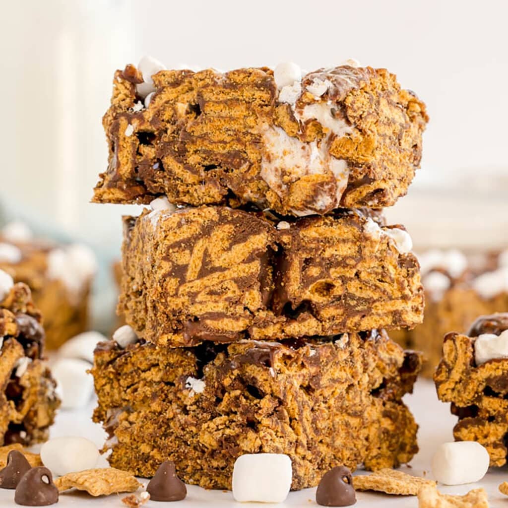 Stack of Golden Grahams s’mores bars topped with mini marshmallows.
