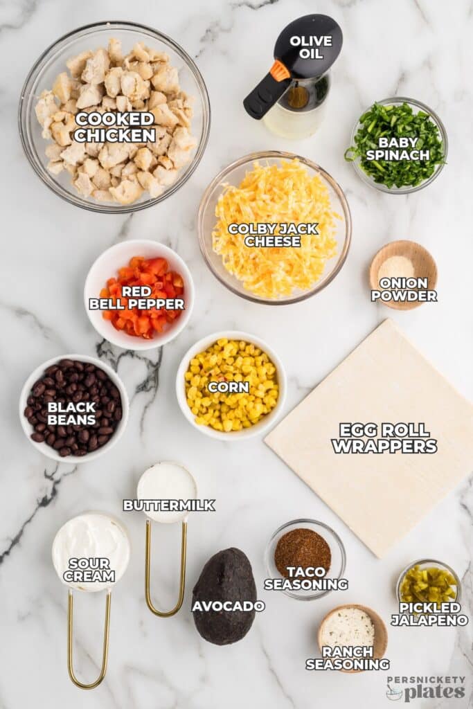 Flat lay of labeled ingredients for southwest egg rolls on a white counter.
