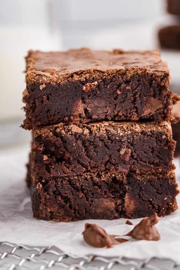 Three stacked brownies showing fudgy centers and crisp edges.