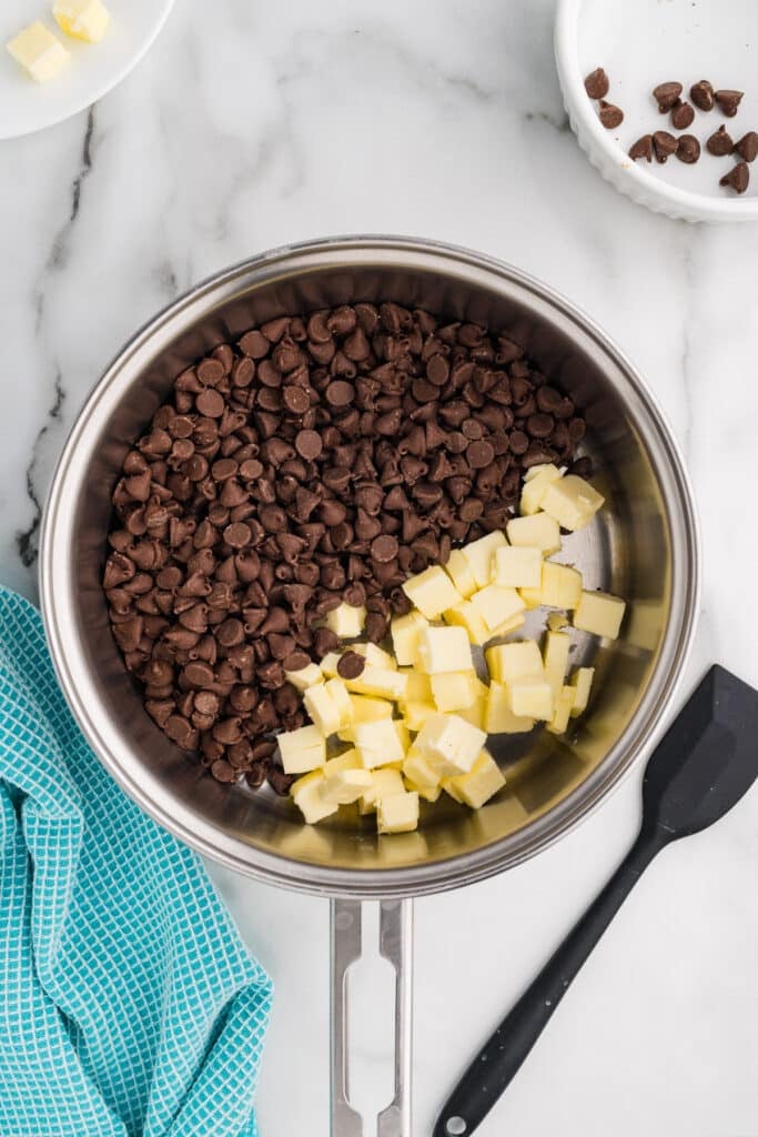 Chocolate chips and cubed butter in a saucepan before melting.