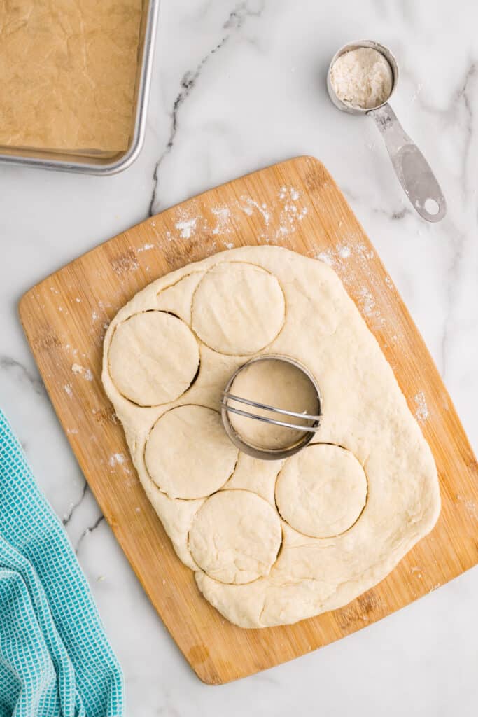 biscuit cutter cutting biscuits from dough.