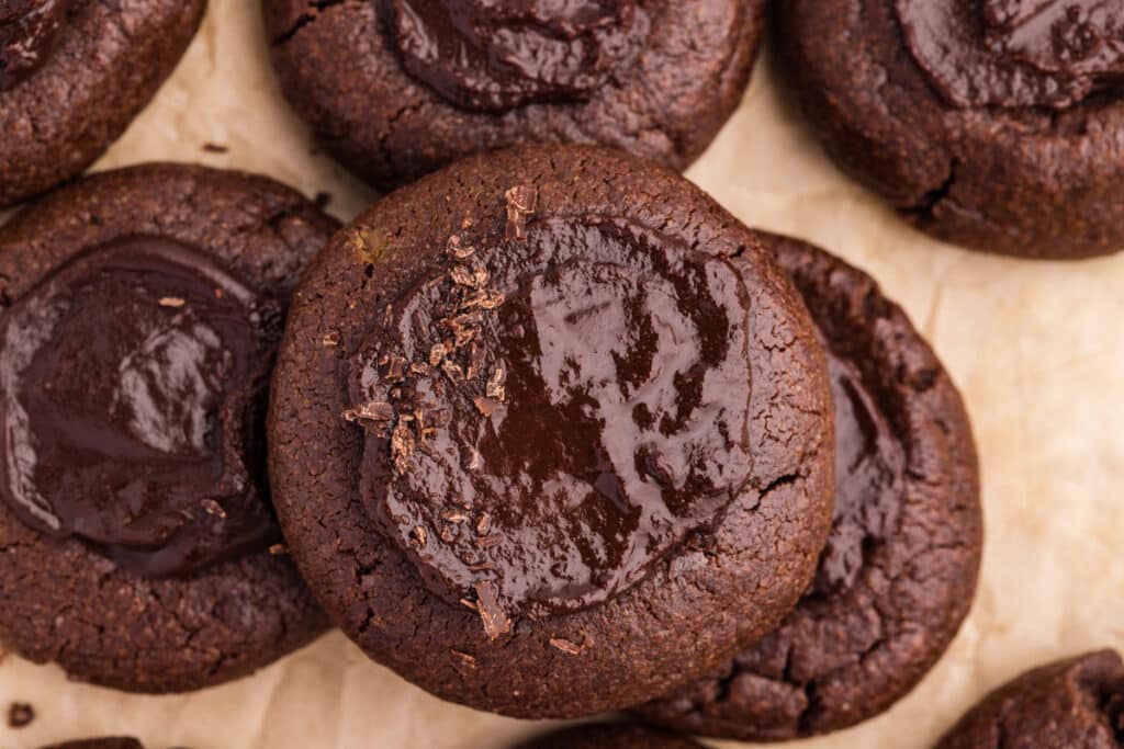 A close-up of a chocolate cookie with a glossy chocolate center.