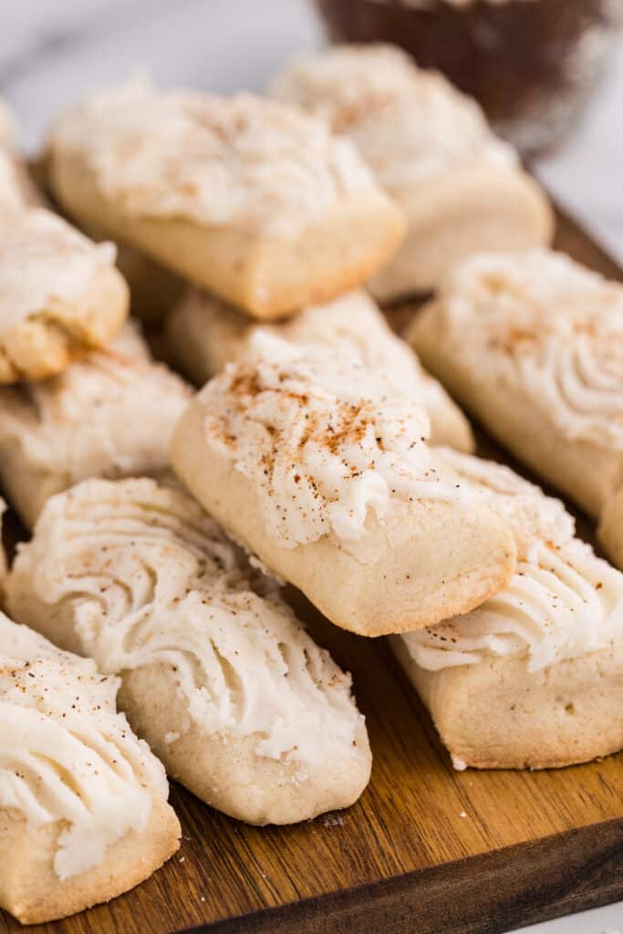 Frosted rectangular cookies arranged on a wooden board.