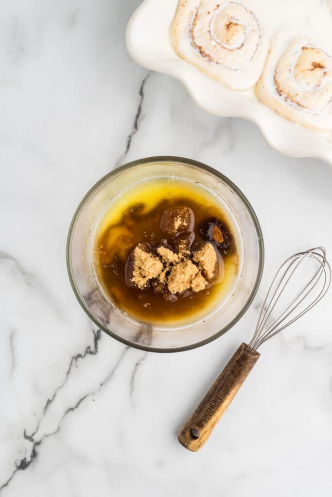 Brown sugar and cinnamon mixture in a glass bowl with a whisk.