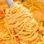 Fork twirling creamy chicken spaghetti noodles.
